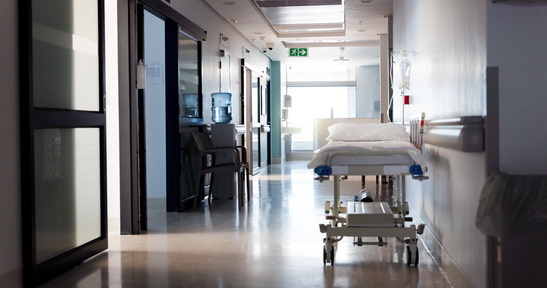 Empty stretcher in a dimly lit hospital emergency department corridor