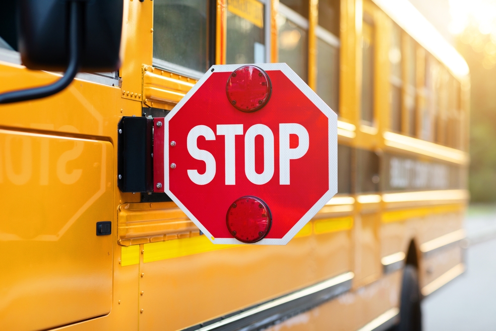 Stop sign extended on a yellow school bus, New Orleans school bus accident lawyer